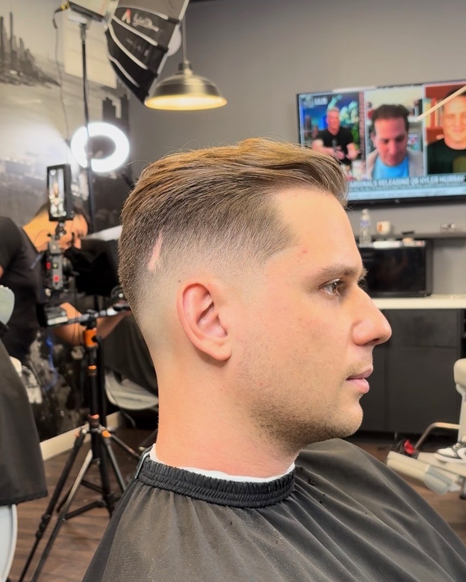 Side-swept top with a mid skin fade, side profile